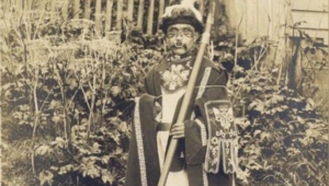 Indian in ceremonial costume with a rod. Territory of Alaska. USA. 1909.